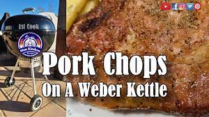 grilled pork chops on a weber kettle