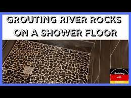 grouting river rocks on a shower floor