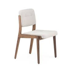 Each dining chair is upholstered in plush velvet with gold nailhead trim. Savvy Dining Chair Dezavo