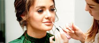 makeup artist applying lipstick