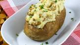 baked potatoes in their jackets with sour cream topping