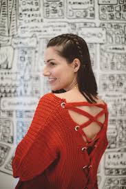 this is a close up shot of a red criss cross back sweater