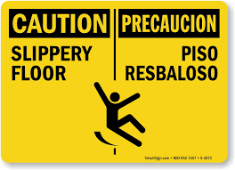 bilingual caution slippery floor sign