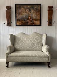 a queen anne style wingback sofa circa