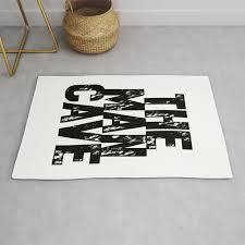 the man cave black text on white rug