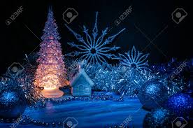 Icy Christmas Tree Glowing With Yellow Light On A Blue Background