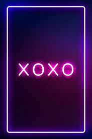 Glowing XOXO neon typography on a dark ...