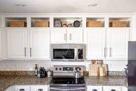 Any crown molding or trim will continue around the room, above the cabinetry. Kitchen Makeover Part 1 Farmhouse Touches And Ceiling Height Cabinets With Love Mercedes