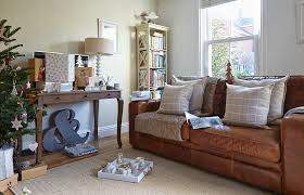 ter cushions on brown leather sofa