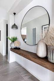 entryway with large round mirror