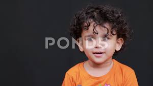 cute indian baby boy playing with a