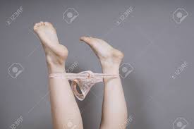Feet In The Air With Thong Panties Around Ankles - Unrecognizable Woman  Undressing Stock Photo, Picture and Royalty Free Image. Image 134867310.