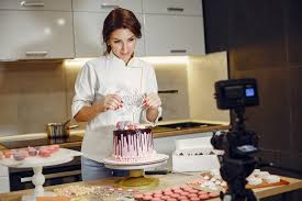 Online cake ordering with cakes.com. Positive Woman Presenting Cake Decoration During Pastry Class Online In Contemporary Kitchen Free Stock Photo