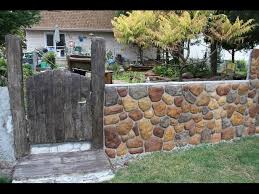 Chain Link Fence To A Stone Wall