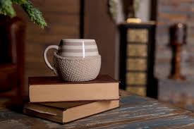Big White Cup On Books On Wooden Table