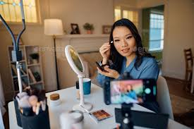 asian makeup artist applying eyeshadow