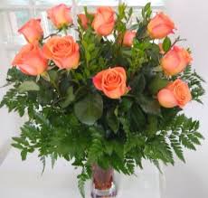Orange Roses Arranged In A Vase In