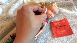 take the makeup off a doll and re paint