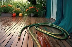 Garden Hose On Wooden Deck With Water Leak