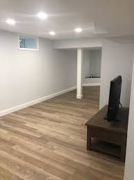 Suitable vinyl flooring for basements pretty much includes all vinyl flooring, but if you're looking for a floating floor that requires no adhesive and goes directly over concrete, two options stand out: Light Basement Coretec Wheldon Oak Vinyl Flooring