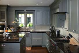 The grey kitchen cabinets rise from the floor to the ceiling in this elegant kitchen. Grey Cabinets With Black Counters Wood Floors Countertops Color Appliance House Grey Painted Kitchen Diy Kitchen Cabinets Makeover Grey Kitchen Designs