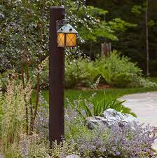 Compare click to add item bel air lighting parsons white outdoor post light to the compare list. Exterior Wall Light Mounted On Log Post Rustic Outdoor Outdoor Post Lights Rustic Outdoor Lighting Solar Lights Garden