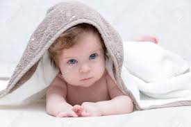 But it seems like, when it comes to babies, people tend to fall in love with full, round faces and big, beautiful eyes. Cute Newborn Baby Girl With Beautiful Blue Eyes On A White Terry Coverlet Adorable Baby Looking Out Under A White Blanket Or Towel Sad Baby Girl In White Towel After Shower Stock
