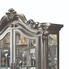 curio cabinet with scrolled motifs and
