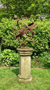 rusted armillary sphere and pedestal