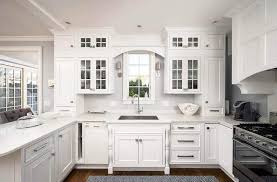 This beautiful kitchen features white cabinets and a custom tile inset over the stove. Kitchen Windows Over Sink Design Decor Ideas Designing Idea