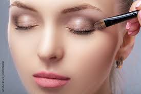 beautiful woman applying brown eye