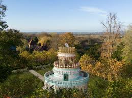 a giant wedding cake rises in the