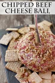 homemade chipped beef cheese ball with a silver cheese spreader pressed into it
