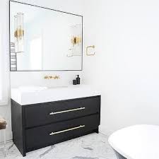 The rubbed bronze fixtures are paired with rubbed bronze shades. Black Quartz Bathroom Countertops Design Ideas
