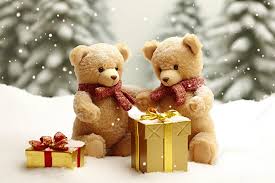 two teddy bears are holding a christmas