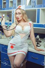Sexy Nurse With Big Breasts Stands In The Laboratory And Holds A  Stethoscope. Stock Photo, Picture and Royalty Free Image. Image 136906565.