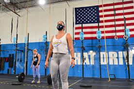 Marjorie taylor greene, center, with supporters at an event in rome, ga., on tuesday night. Coronavirus Splits Crossfit In Two