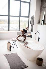 Having Foamy Bath. Naked Dark-skinned Woman Feeling Good While Having Foamy  Bath At The Weekend Stock Photo, Picture and Royalty Free Image. Image  132407306.