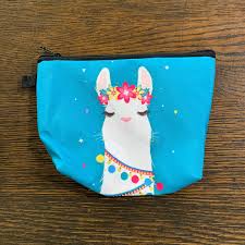 blue makeup bag with white cartoon alpaca