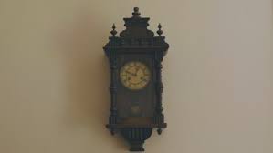 A Grandfather Clock Hanging On The Wall