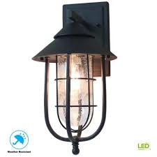 Home Decorators Collection Wisteria Collection 1 Light Sand Black Outdoor Wall Lantern Sconce With Clear Glass Shade 17546 The Home Depot