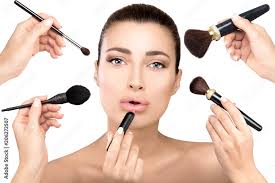 beauty model with makeup brushes in