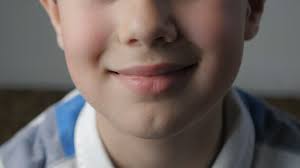 close up of the boy s lips he is happy