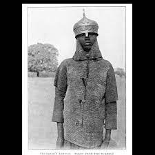 Nigerian CodeX on Instagram: "1900s - Hausa man wearing a christian  crusader armor taken from a tuareg warrior(might also be ottoman armour,  based on the top helmet part). He also wears a