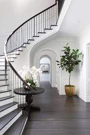 Christine orlando at may 2, 2021 10:00 am. Chic Classic Foyer Features A Curved Staircase Wall Filled With A Black Round Table And Orchids Hamptons House House Design Staircase Design