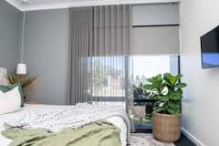 Can you hang curtains over blinds?