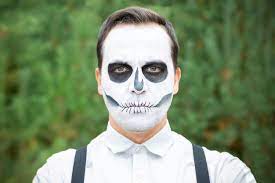 a young man with a skeleton makeup