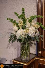 When arranging flowers in a tall or cylinder vase, it's important to consider which flowers you are choosing. Tall Arrangements In Clear Glass Vases Created Using White Hydrangea White Rose Hydrangea Flower Arrangements Hydrangea Arrangements Large Flower Arrangements