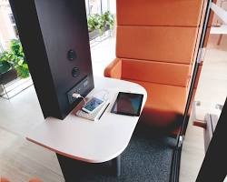 Image of Pod interior with a work desk and charging outlets