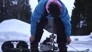 riding a homemade gas powered snowboard
